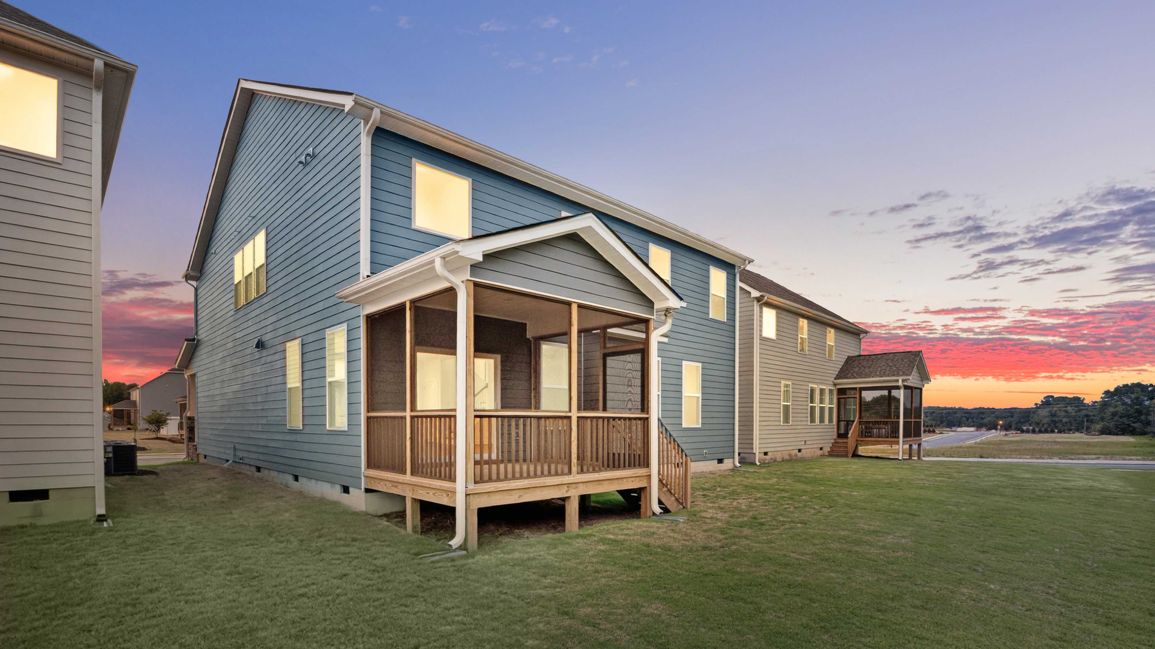 backyard with covered and screened back deck twilight photo