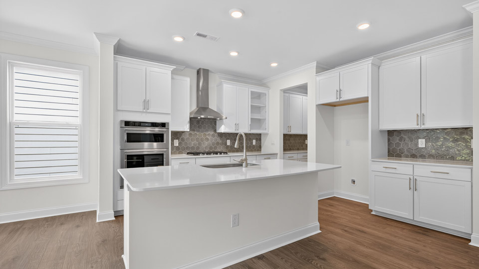 kitchen with white cabinets quartz countertops and stainless steel appliances