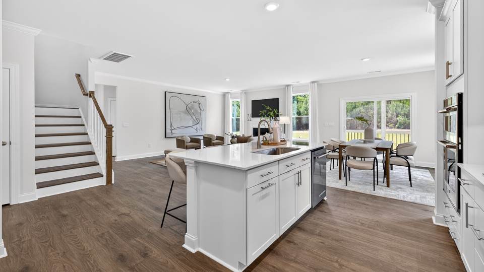 kitchen with quartz counters, kitchen island, pantry, stainless steel appliances