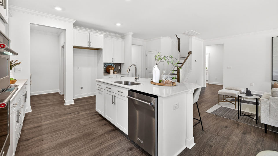 kitchen with quartz counters, kitchen island, pantry, stainless steel appliances