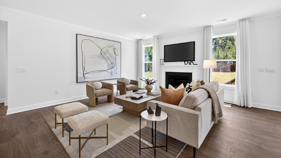 open concept living space with large windows, fireplace