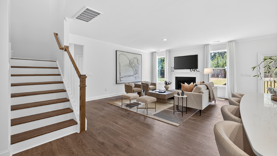 open concept living space with large windows, fireplace