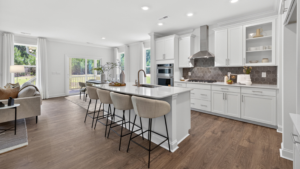 kitchen with quartz counters, kitchen island, pantry, stainless steel appliances