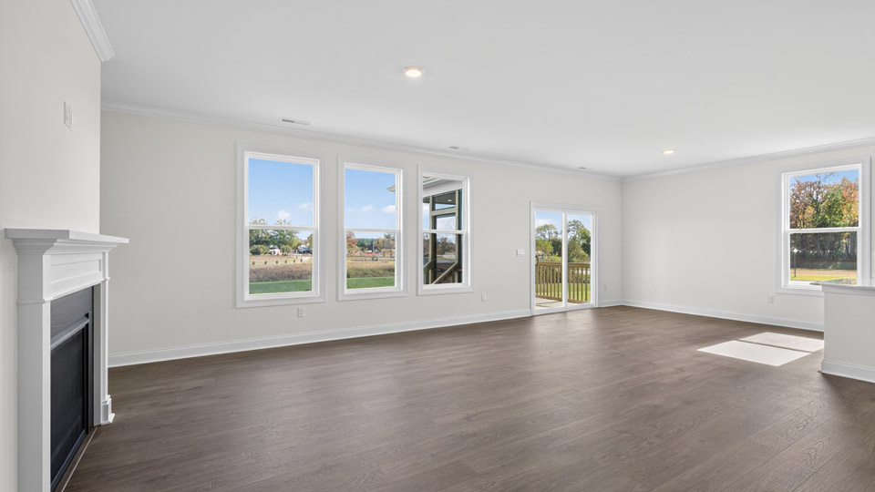 open concept living room with fireplace and revwood flooring