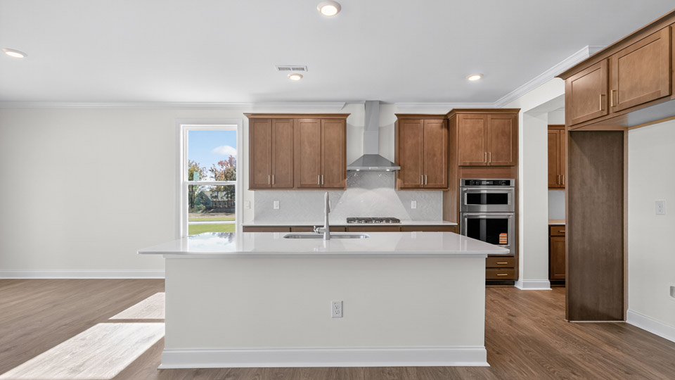 kitchen with brown cabinets quartz countertops and stainless steel appliances