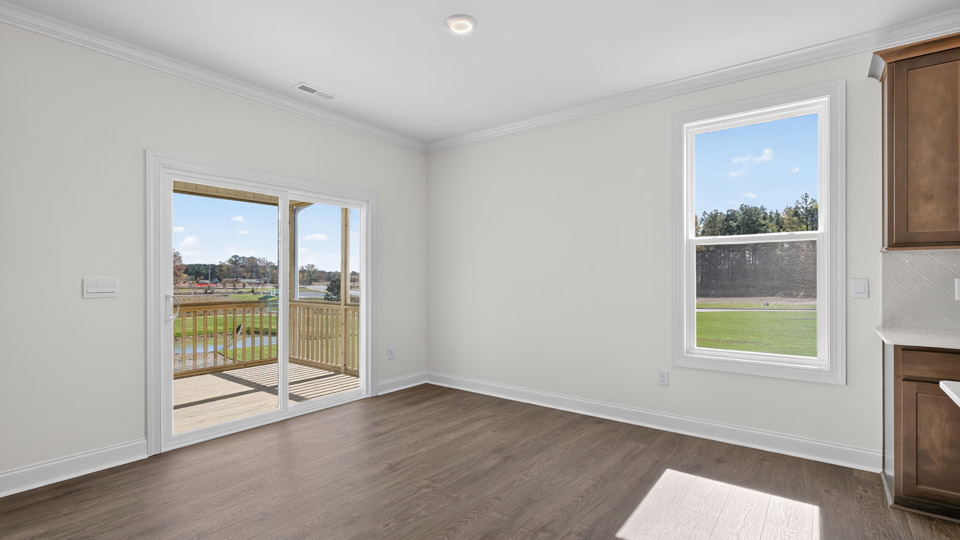breakfast area with sliding glass doors and revwood flooring