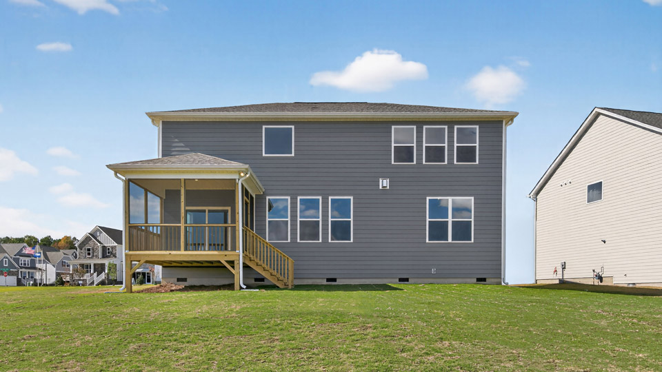 back exterior of jordan b with deck and yard