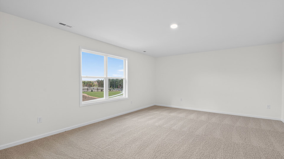 upstairs loft area with large windows and carpeting
