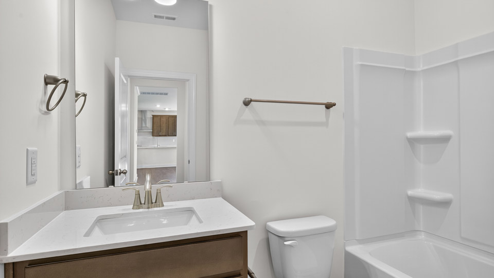 secondary bathroom with shower tub combo and single vanity sink