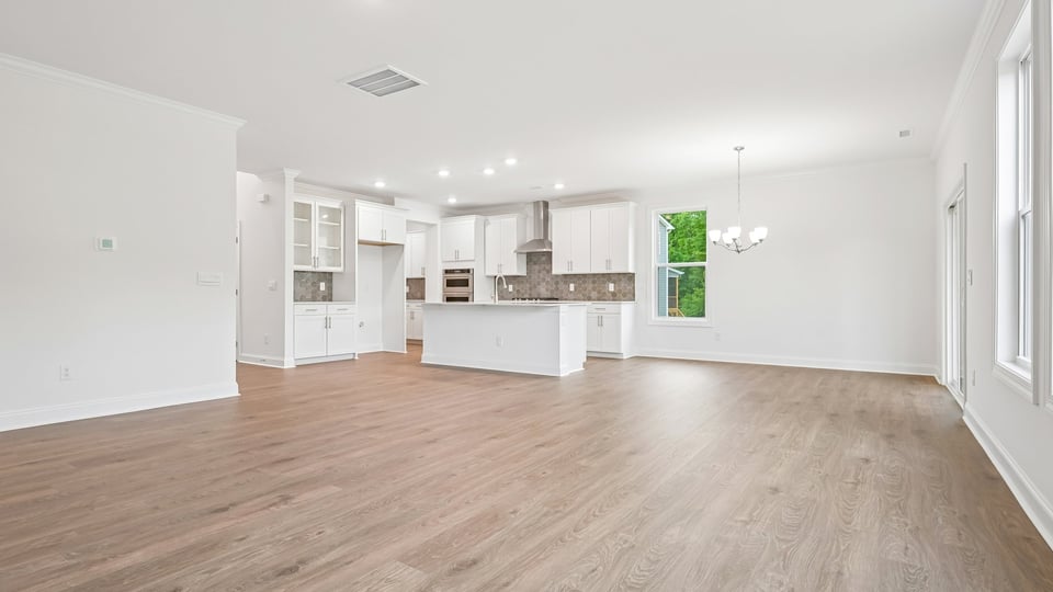 open concept living space with large windows, fireplace