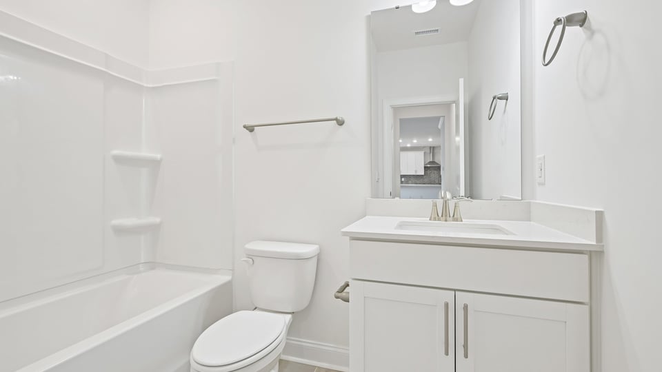 secondary bathroom with shower tub combo and single vanity sink