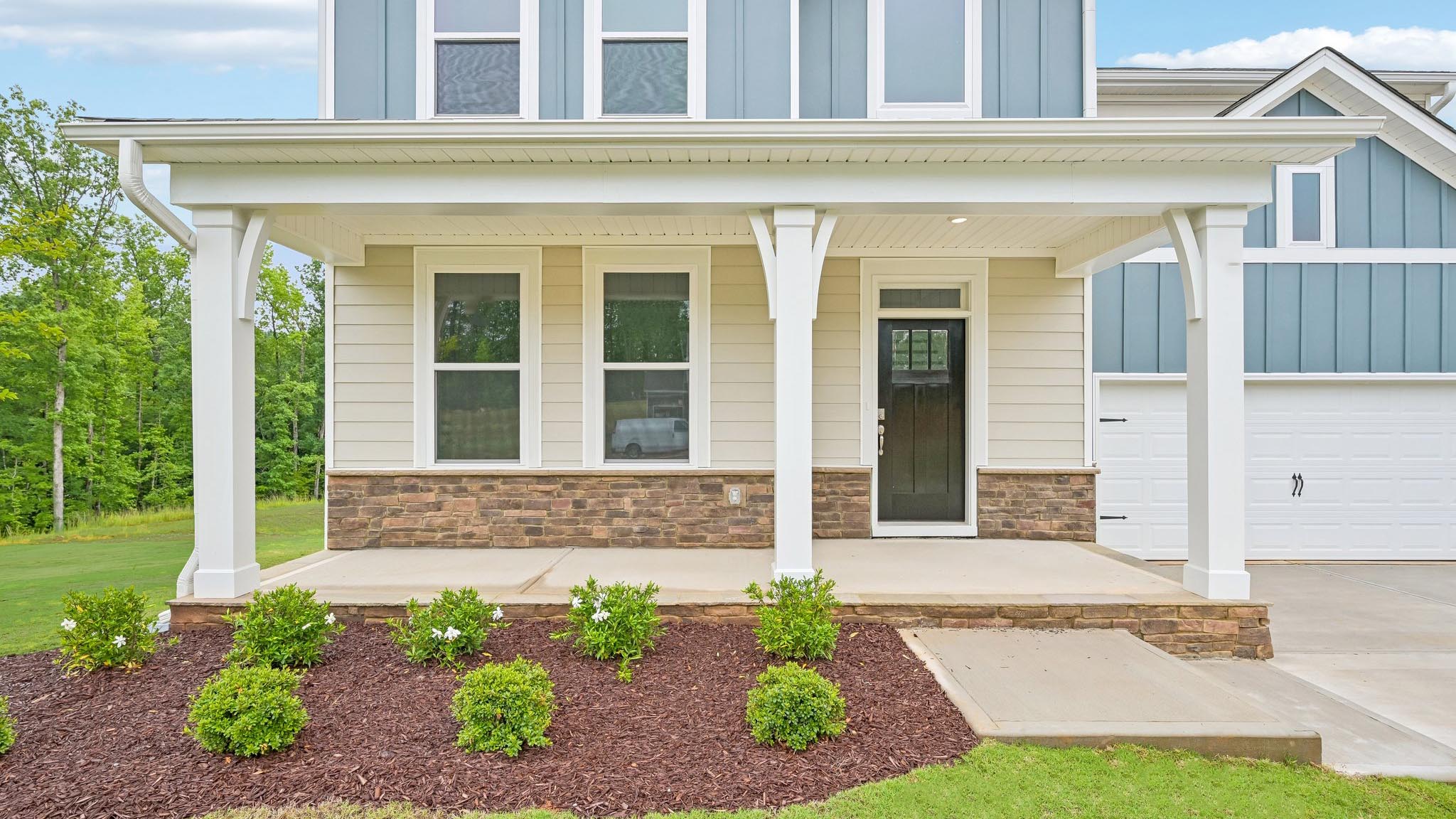 front porch of jordan c with 3 car garage