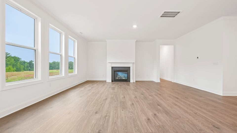 open concept living space with large windows, fireplace