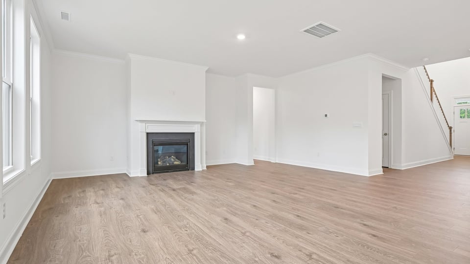 open concept living space with large windows, fireplace