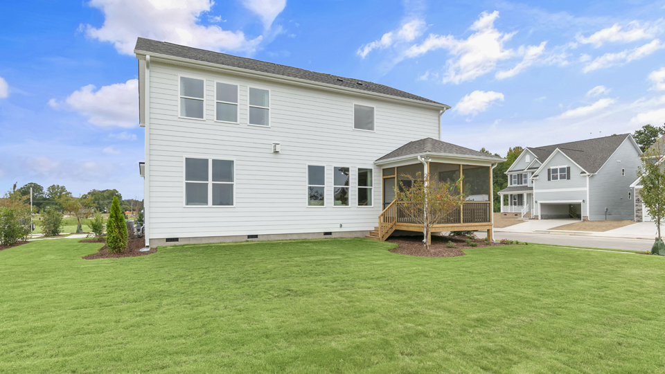 spacious backyard with covered and screened back deck