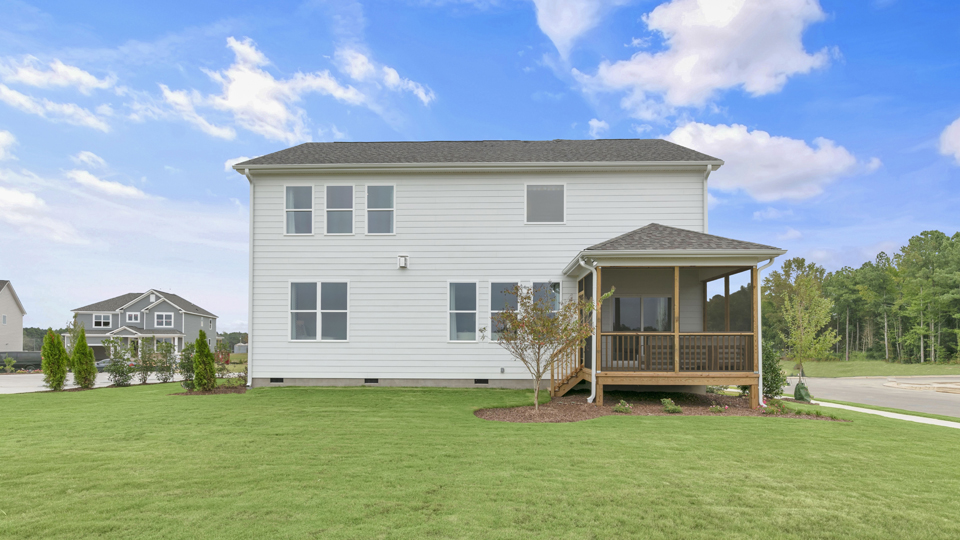 spacious backyard with covered and screened back deck