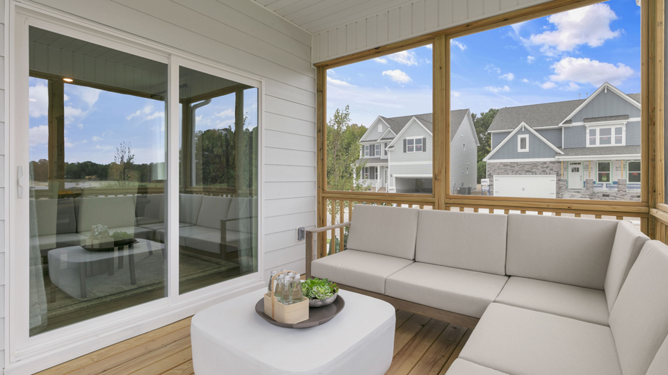 covered and screened deck with sliding glass doors