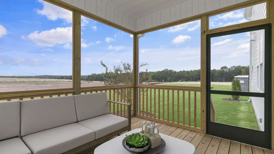 covered and screened deck with sliding glass doors
