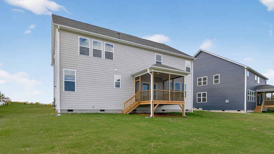 spacious backyard with covered and screened in back deck