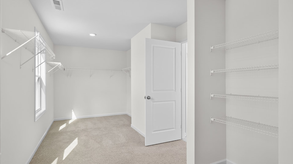 walk-in closet with wire shelving and window for natural lighting