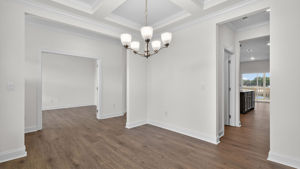 dining room with revwood flooring and coffered ceiling
