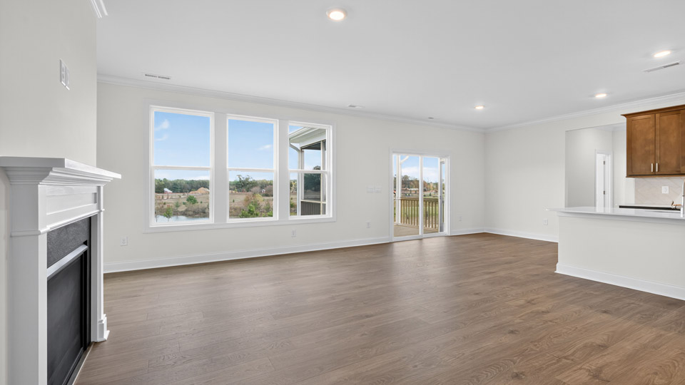 open concept living room with fireplace and revwood flooring