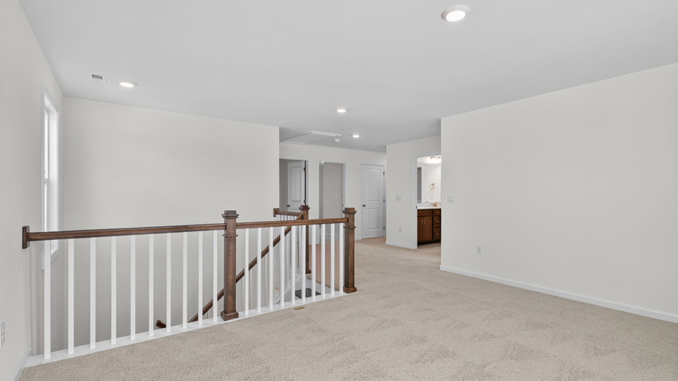 loft with open railing and carpet flooring