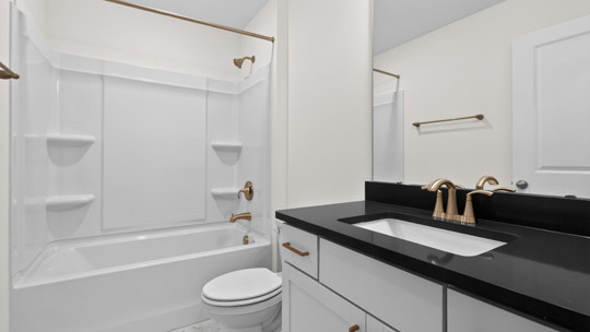 bathroom with tub shower combo and quartz countertops
