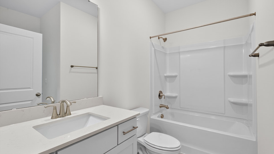 bathroom with quartz countertops and tub shower combo