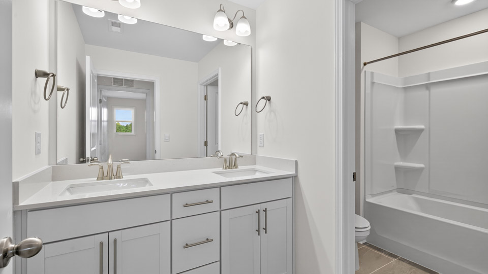 bathroom with tub shower combo and quartz countertops