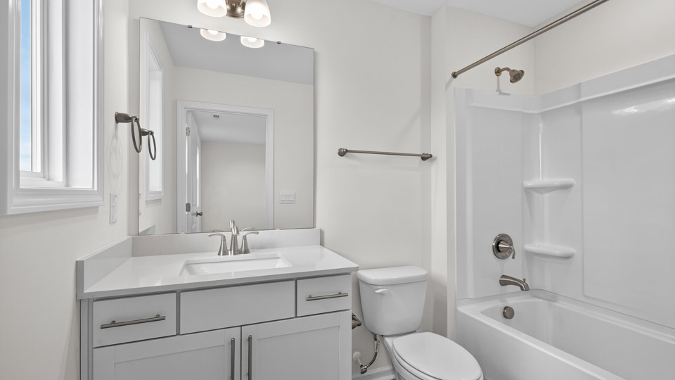 bathroom with tub shower combo and quartz countertops