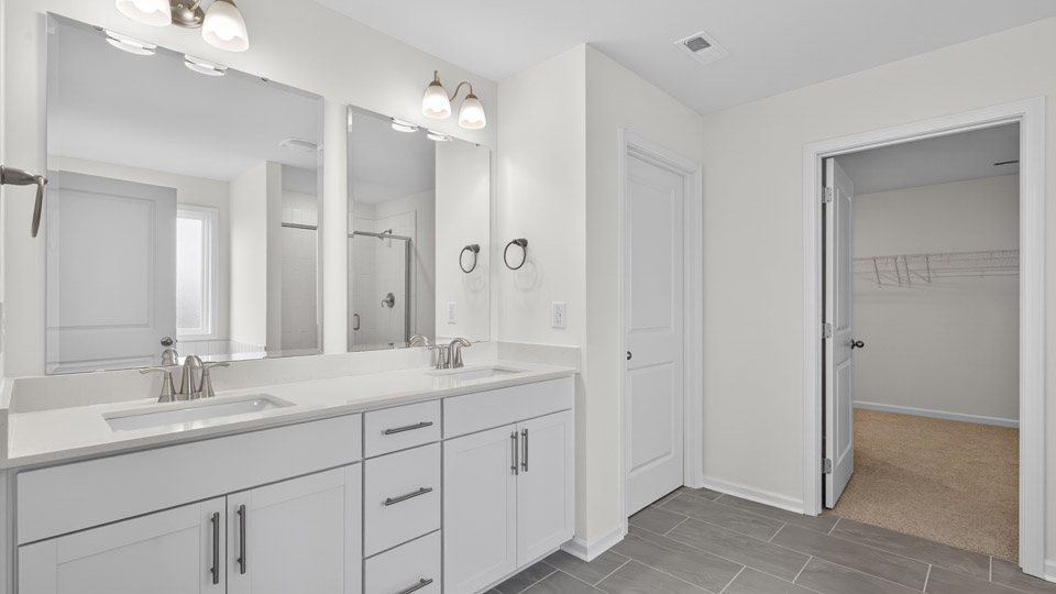 bathroom with dual vanity and quartz countertops