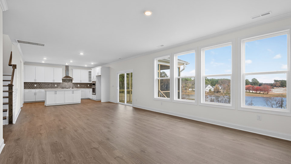 kitchen overlooking spacious family room with revwood flooring