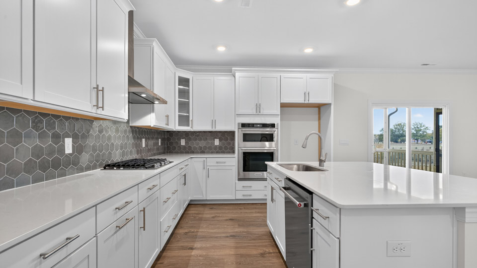kitchen with island quartz countertops and stainless steel appliances