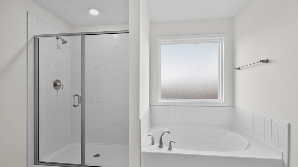 bathroom with separate tub and walk-in shower