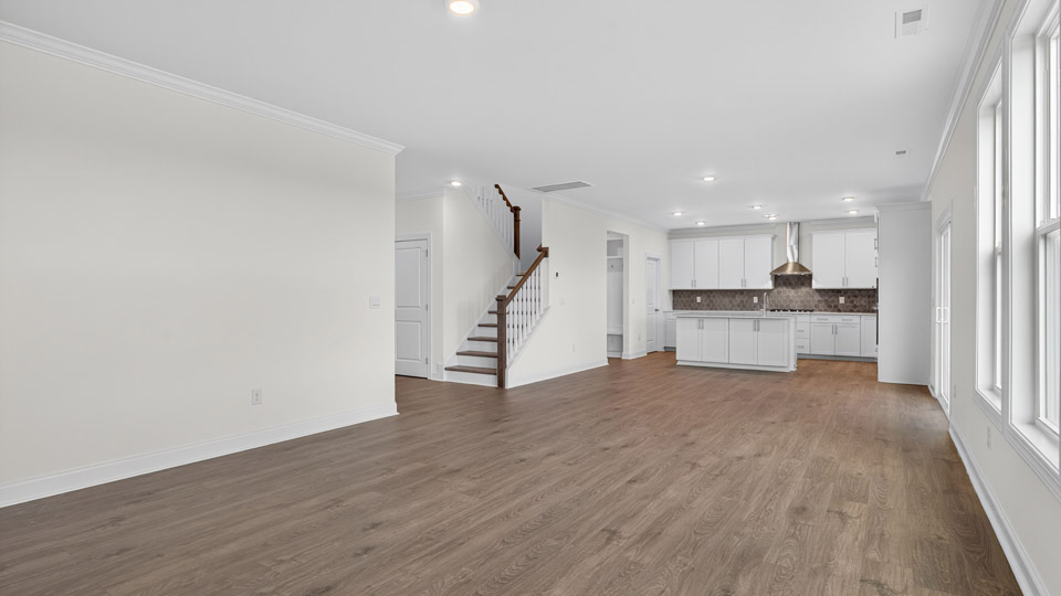 kitchen overlooking spacious living room with revwood flooring