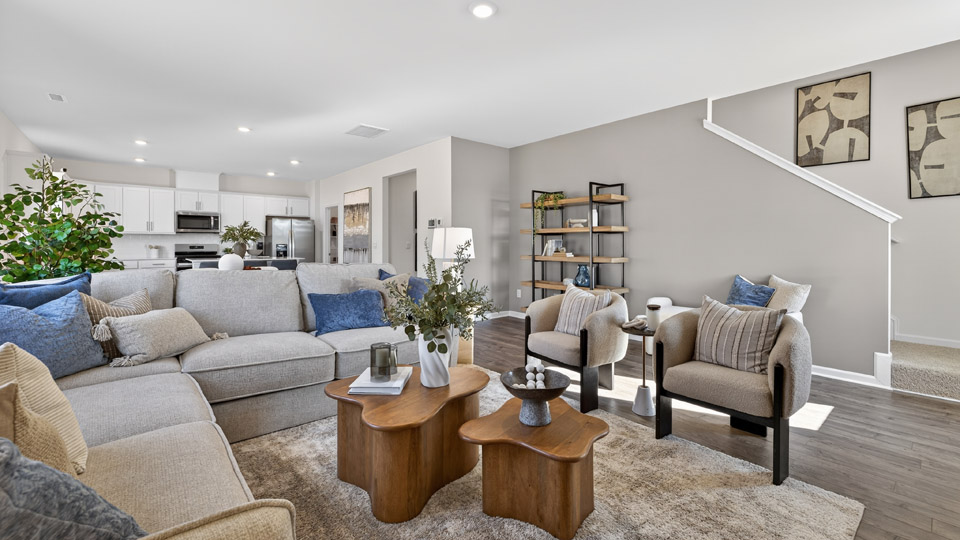 open concept living area and dining area overlooked by kitchen