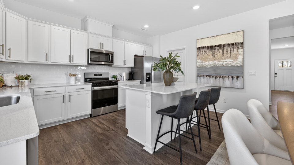 kitchen with white cabinets and quartz countertops and island