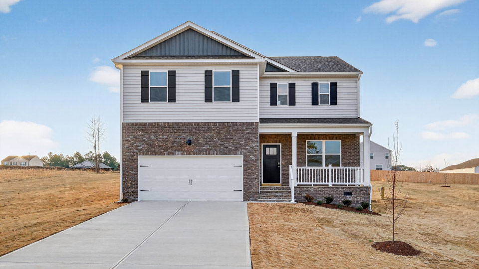 Two story home with white colored siding with a two car garage