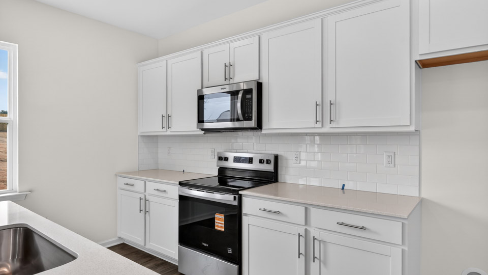 Kitchen with white cabinets and stainless steel appliances.
