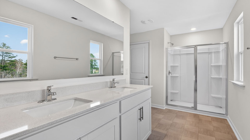 Primary bathroom with double sink and walk-in shower