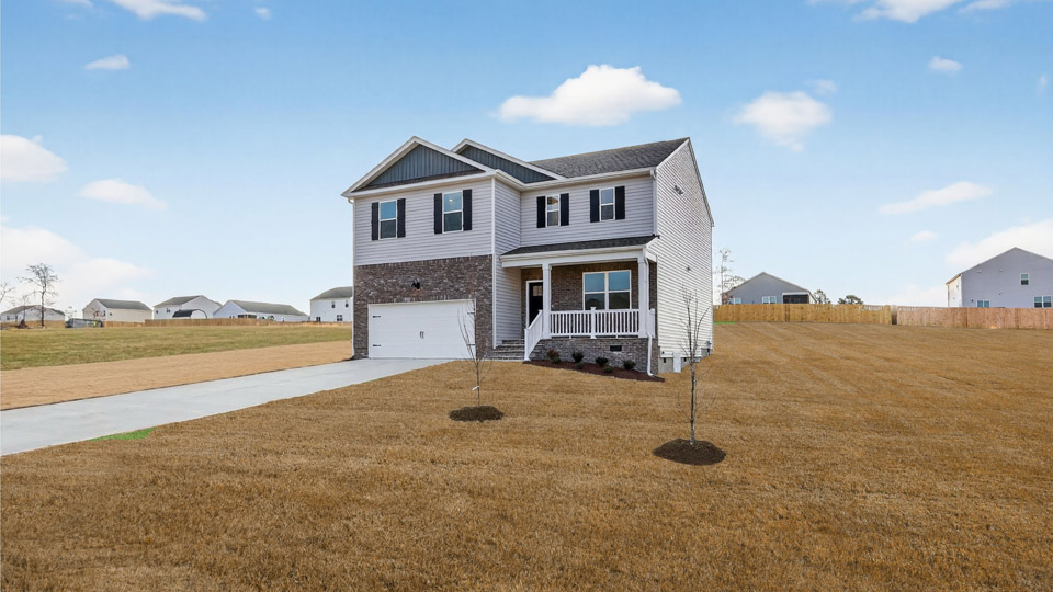 Two story home with white colored siding with a two car garage