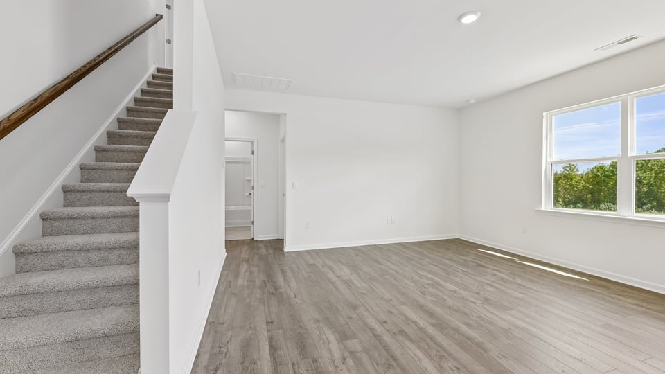 carpeted staircase and living room
