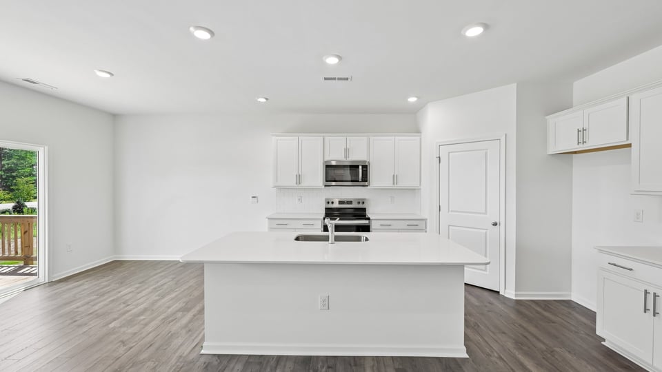 kitchen with white cabinets quartz countertops and center island