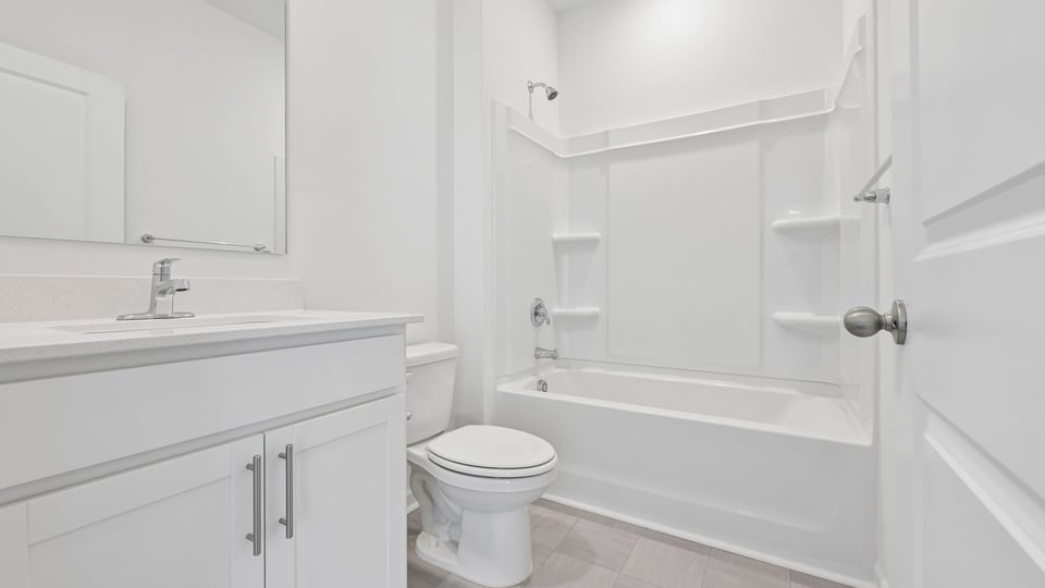 bathroom with white cabinets and tub shower combo
