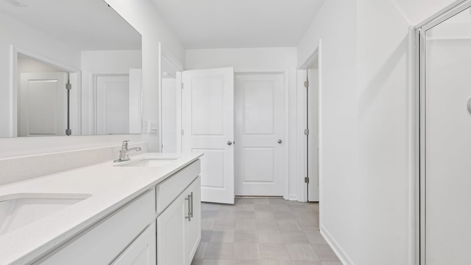 bathroom with walkin shower white cabients and quartz countertops