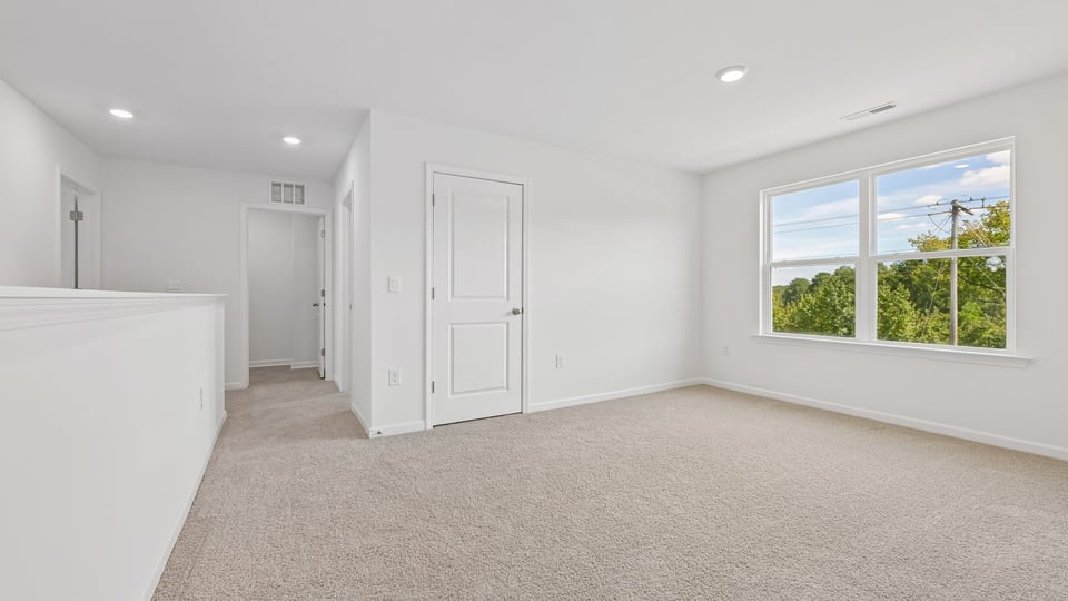 loft with carpet flooring