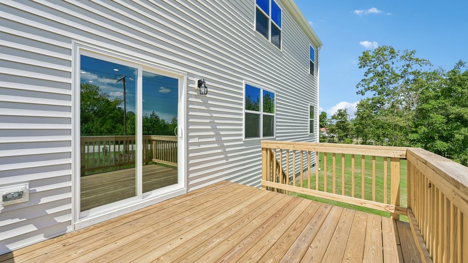 uncovered back deck with sliding glass doors