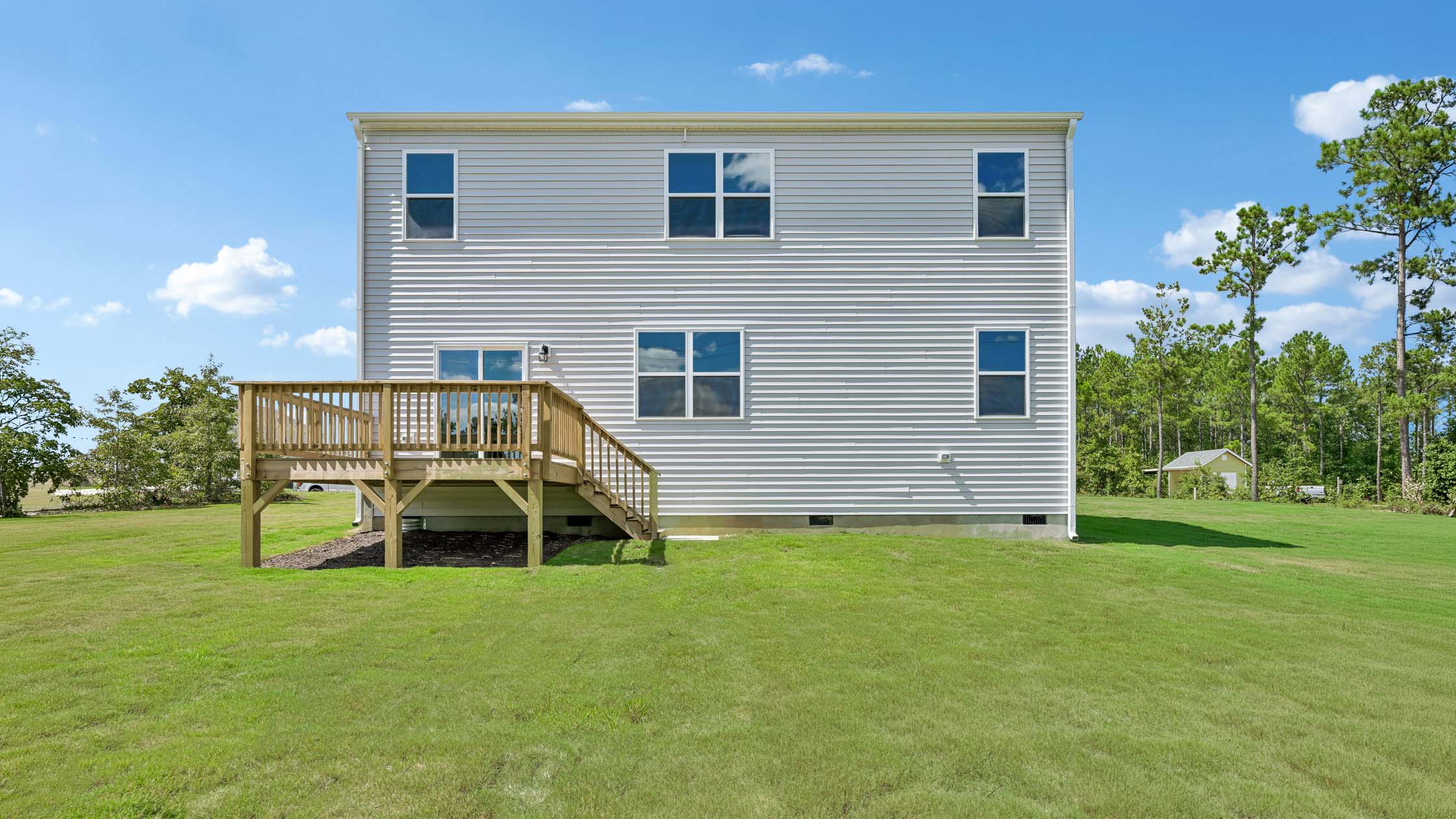 back of home with uncovered back deck