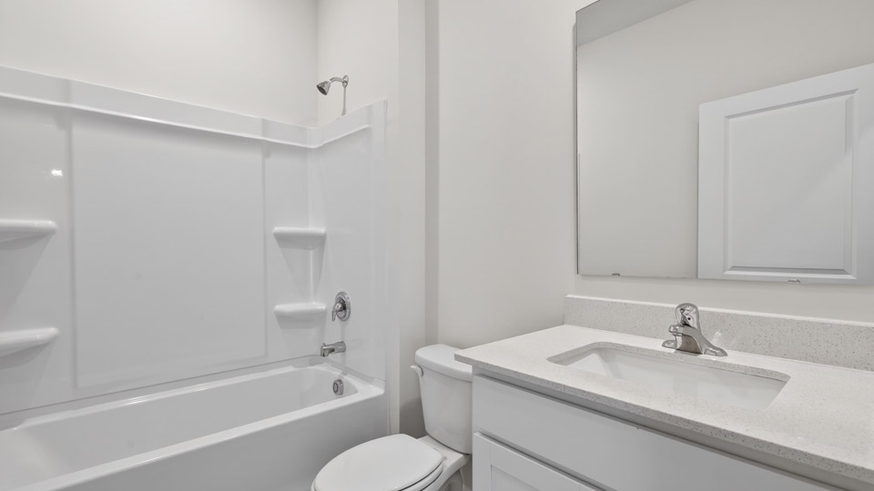 secondary bathroom with shower tub combo and single vanity sink